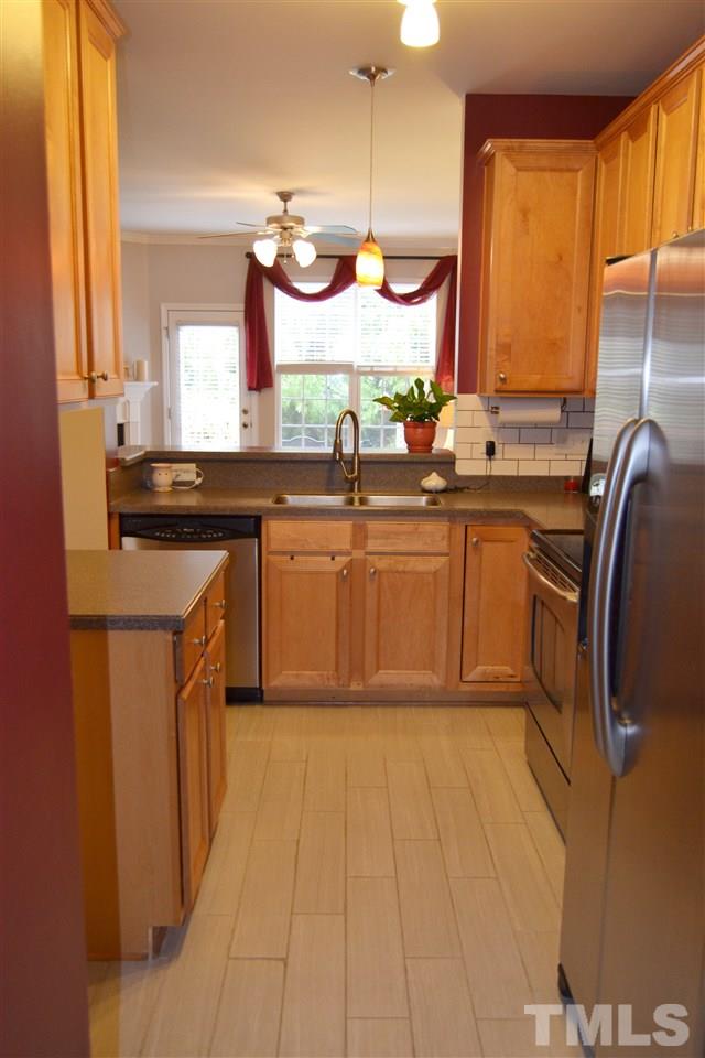 7840 Silverthread Lane Raleigh, NC 27617 - Photo 11 of 21 a kitchen with stainless steel appliances granite countertop a sink a stove and a microwave