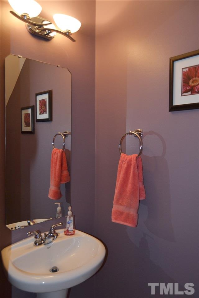 7840 Silverthread Lane Raleigh, NC 27617 - Photo 16 of 21 a bathroom with a sink and a mirror