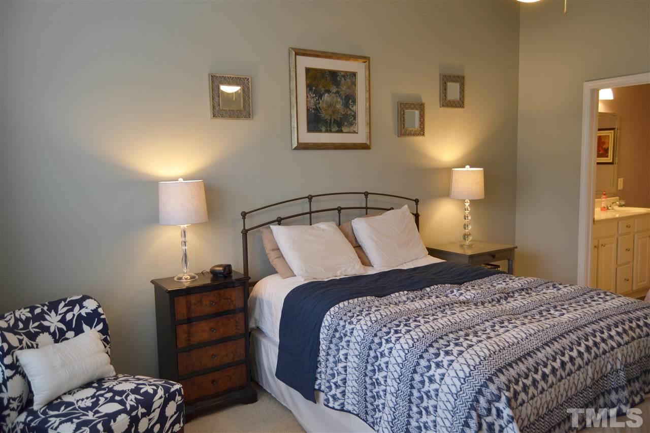 7840 Silverthread Lane Raleigh, NC 27617 - Photo 17 of 21 a bedroom with a bed and lamps