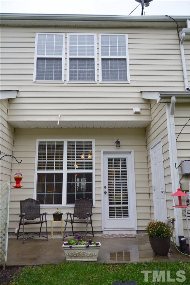 7840 Silverthread Lane Raleigh, NC 27617 - Photo 20 of 21 a front view of a house with a yard and sitting area