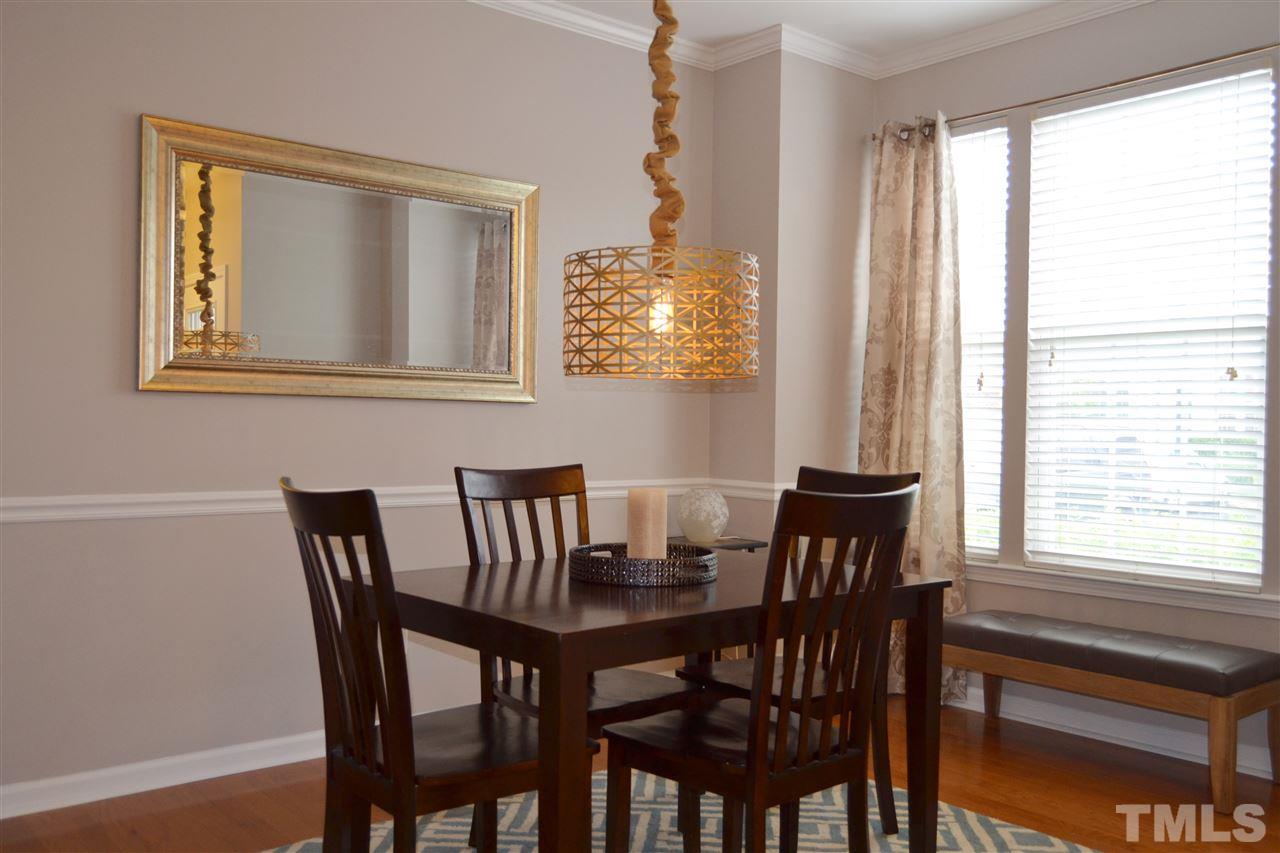 7840 Silverthread Lane Raleigh, NC 27617 - Photo 4 of 21 a view of a dining room with furniture and windows