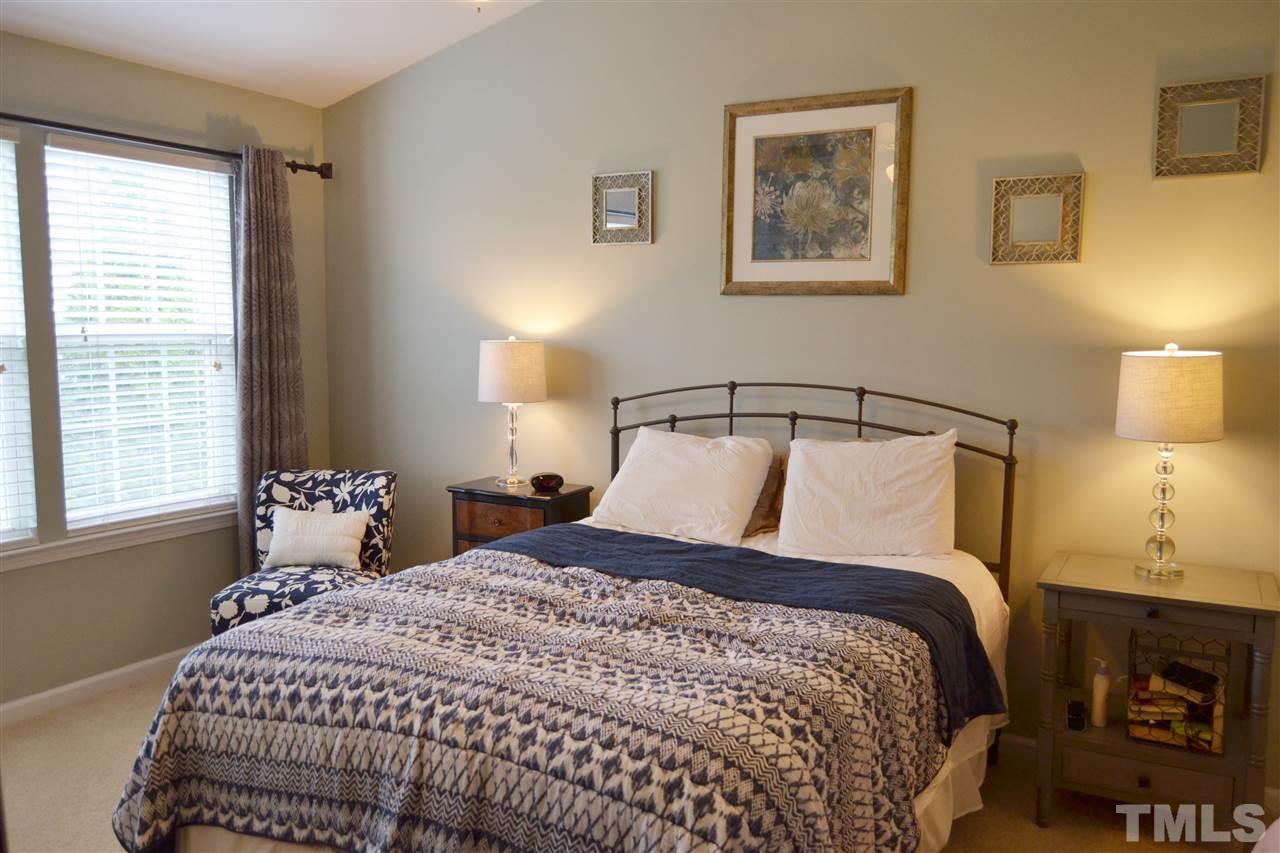 7840 Silverthread Lane Raleigh, NC 27617 - Photo 5 of 21 a bedroom with a bed and lamp