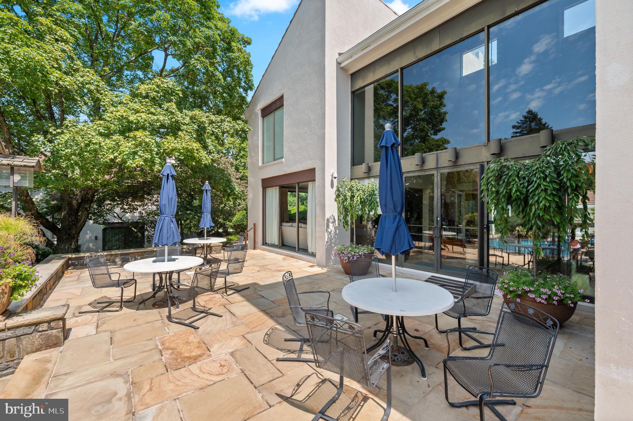 8 Brettagne Devon, PA 19333 - Photo 38 of 38 a view of a patio with table and chairs potted plants and a barbeque