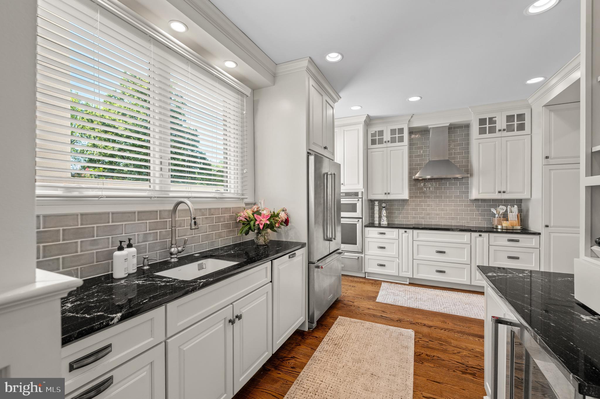 8 Brettagne Devon, PA 19333 - Photo 7 of 38 a large kitchen with stainless steel appliances kitchen island granite countertop a sink and cabinets