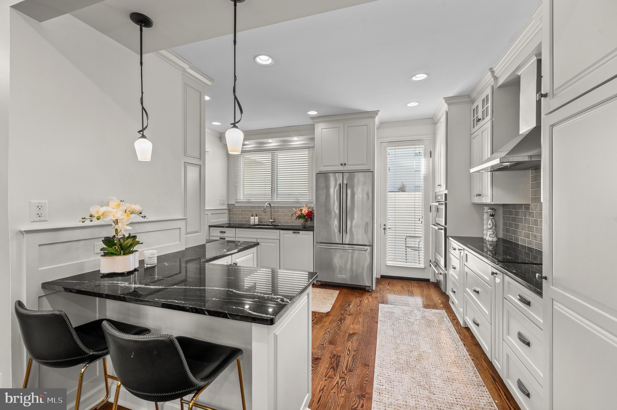 8 Brettagne Devon, PA 19333 - Photo 9 of 38 a kitchen with stainless steel appliances granite countertop sink stove and cabinets