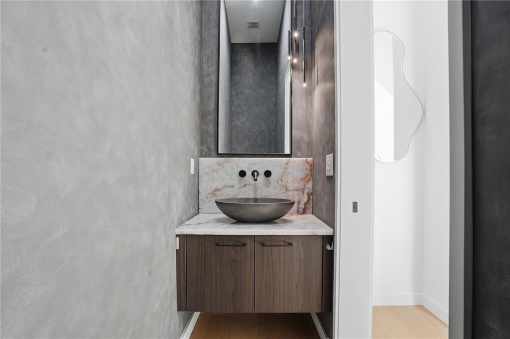 3293 Lenox Place Northeast Atlanta, GA 30324 - Photo 18 of 40 a bathroom with a sink and a mirror