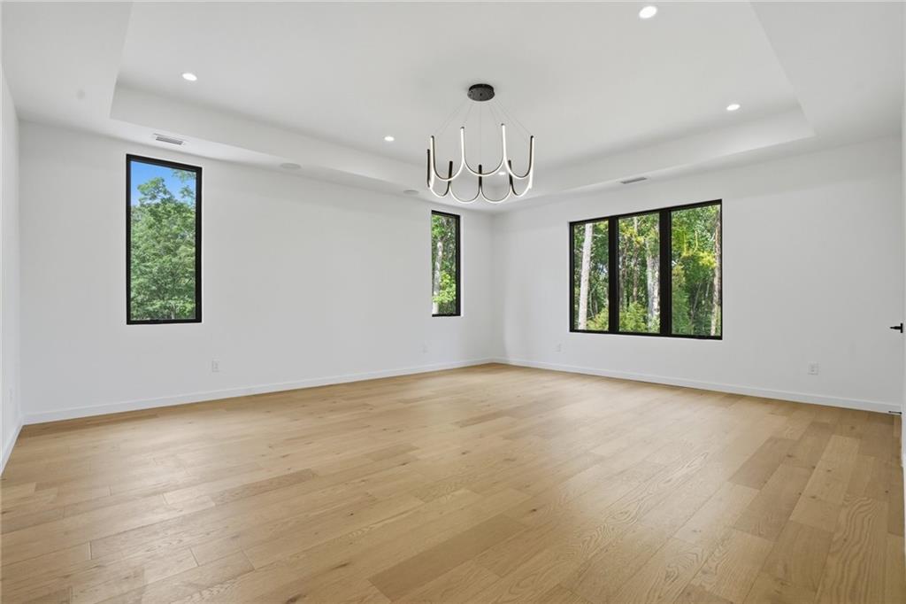 3293 Lenox Place Northeast Atlanta, GA 30324 - Photo 19 of 40 an empty room with windows and chandelier
