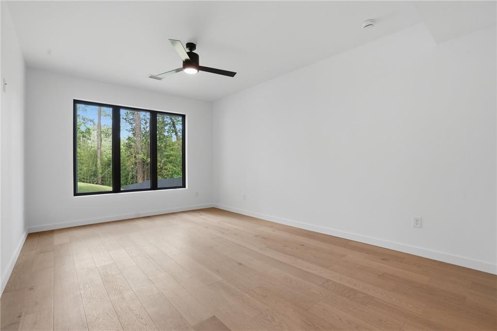 3293 Lenox Place Northeast Atlanta, GA 30324 - Photo 27 of 40 a view of an empty room with wooden floor and a window