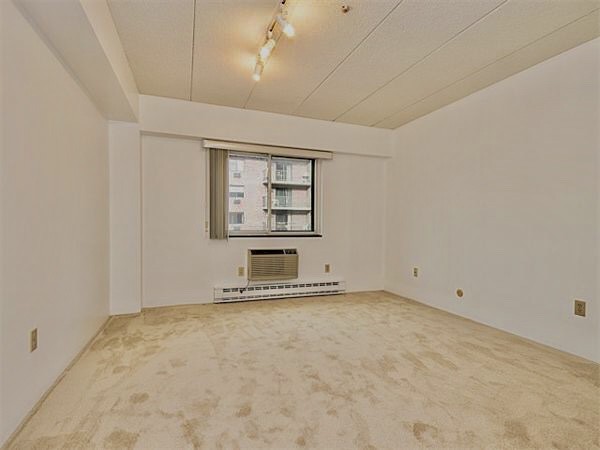 125 Pleasant Street, Unit 309 Brookline, MA 02446 - Photo 3 of 9 an empty room with windows