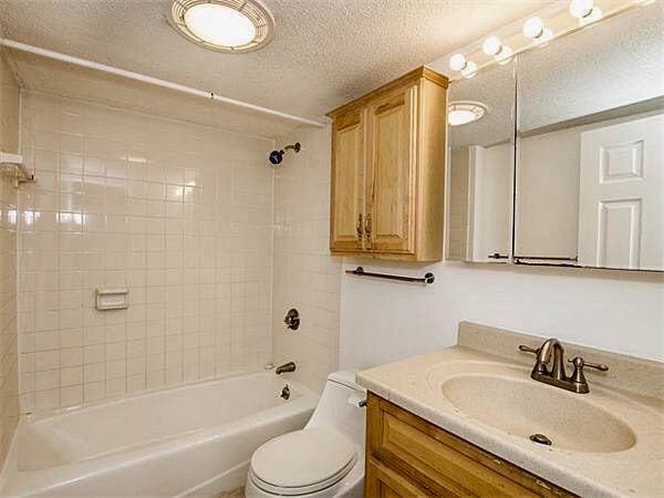 125 Pleasant Street, Unit 309 Brookline, MA 02446 - Photo 5 of 9 a bathroom with a sink toilet and shower