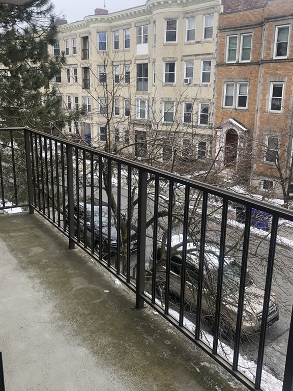 125 Pleasant Street, Unit 309 Brookline, MA 02446 - Photo 6 of 9 a view of a large building from a balcony