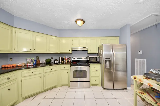 a kitchen with stainless steel appliances a stove a refrigerator and a sink