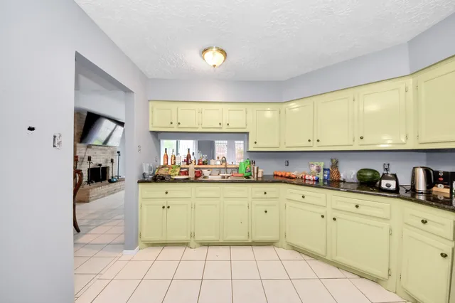a kitchen with sink cabinets and appliances
