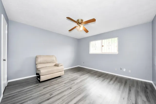 a view of a room with wooden floor and white walls