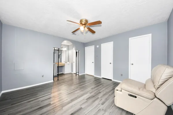 a view of livingroom with hardwood floor and a ceiling fan