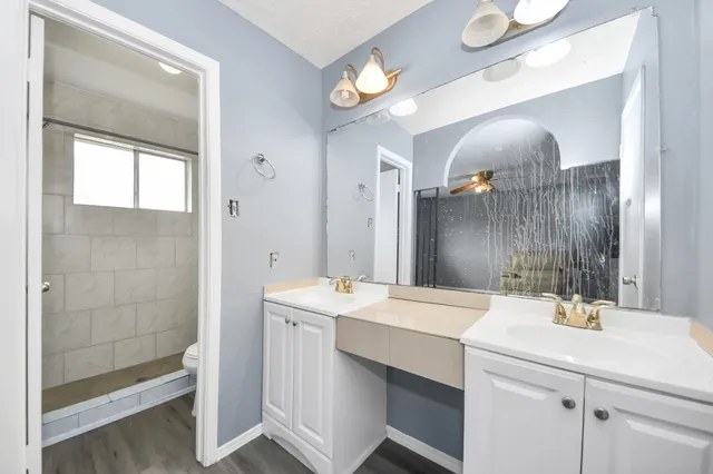a bathroom with a sink a large mirror and a shower