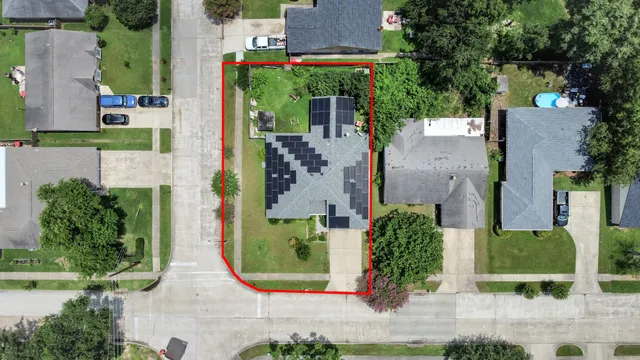 an aerial view of a house with yard