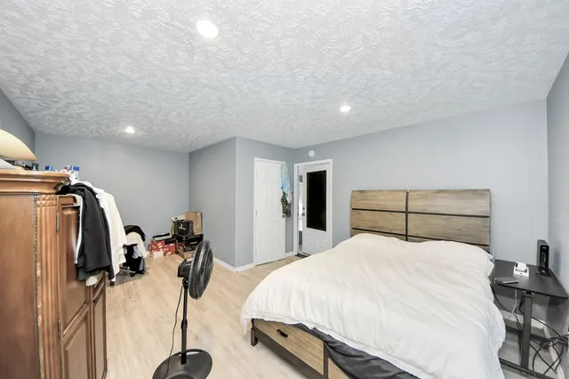 a bedroom with a bed and gym equipment