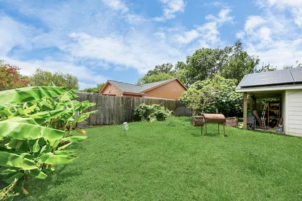 a view of a house with a yard and sitting area