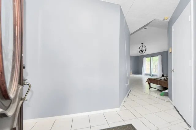 a view of a hallway with couch and a potted plant