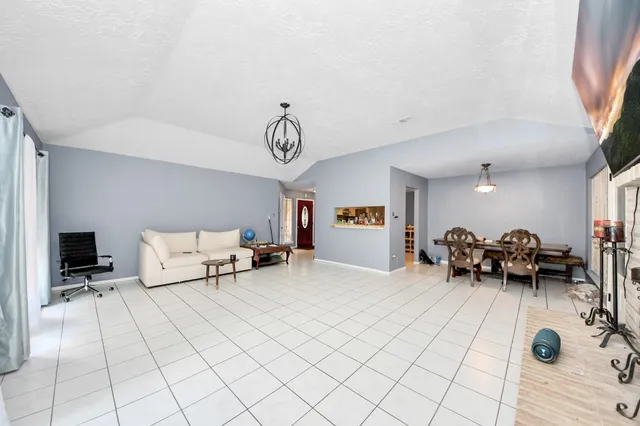 a bed room with a bed and a chair