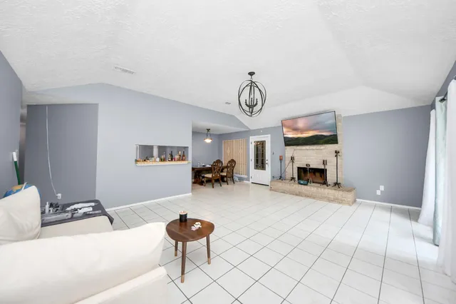 a living room with furniture and a fireplace