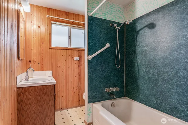 a bathroom with a sink a mirror and a bathtub