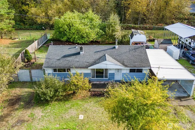 an aerial view of a house with swimming pool garden and patio
