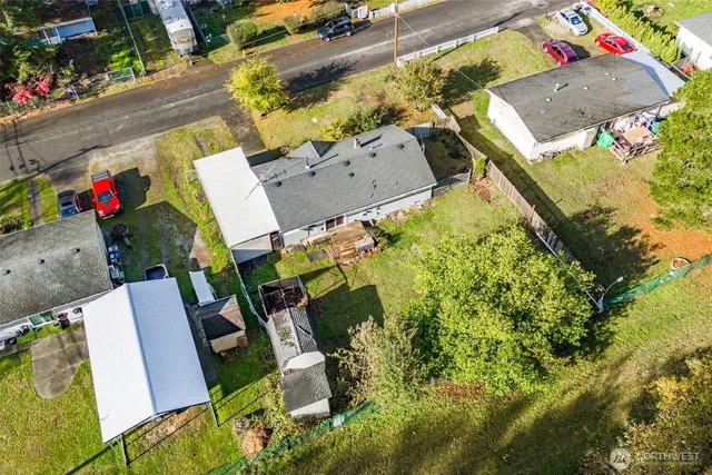 an aerial view of a house with swimming pool and outdoor space