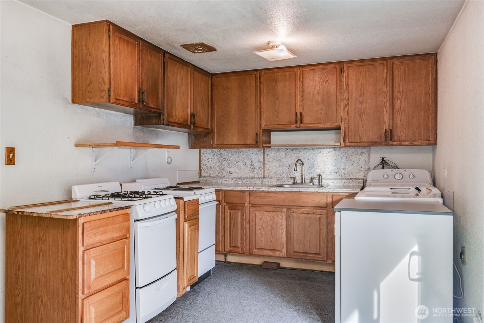 33526 18th Avenue South Federal Way, WA 98003 - Photo 6 of 31 a kitchen with stainless steel appliances granite countertop a stove a sink dishwasher and a refrigerator