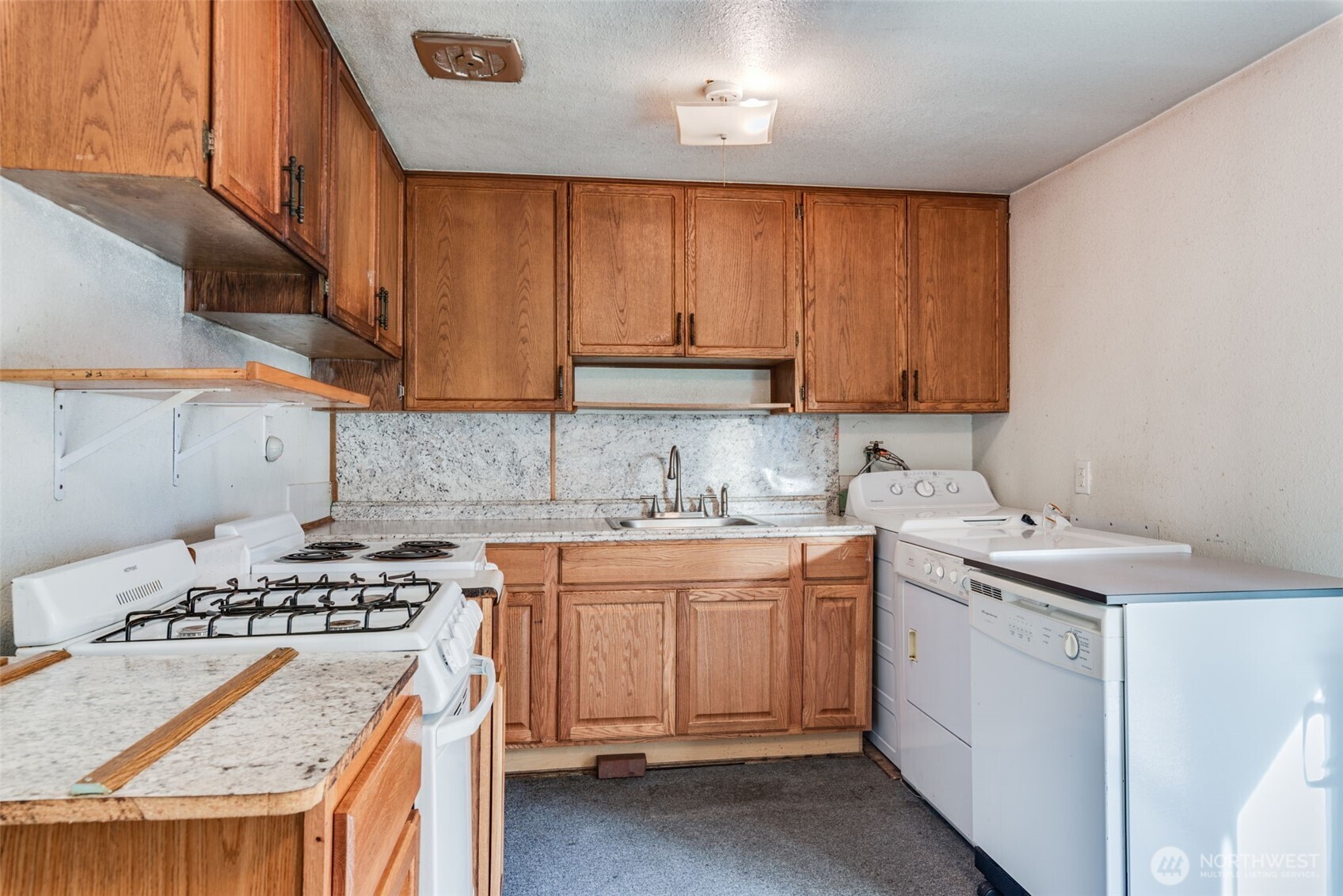 33526 18th Avenue South Federal Way, WA 98003 - Photo 7 of 31 a kitchen with a sink stove and cabinets
