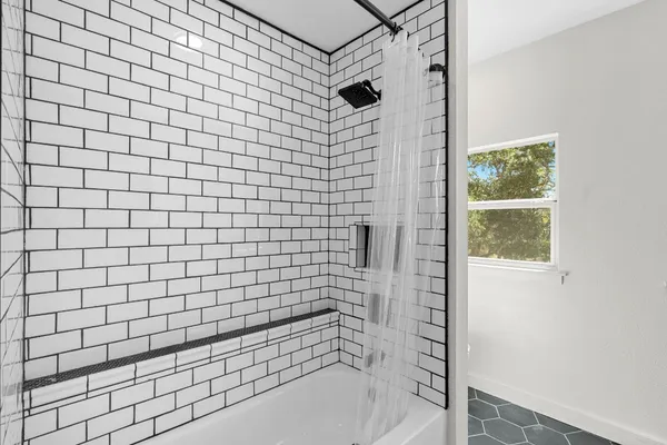 a bathroom with a sink a mirror and shower