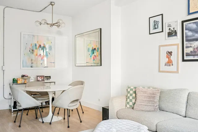 a living room with furniture a couch and painting on the wall