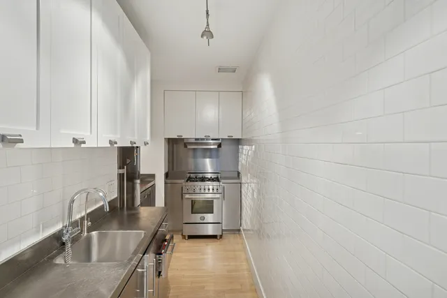 a view of a livingroom with furniture and a dining table with chairs