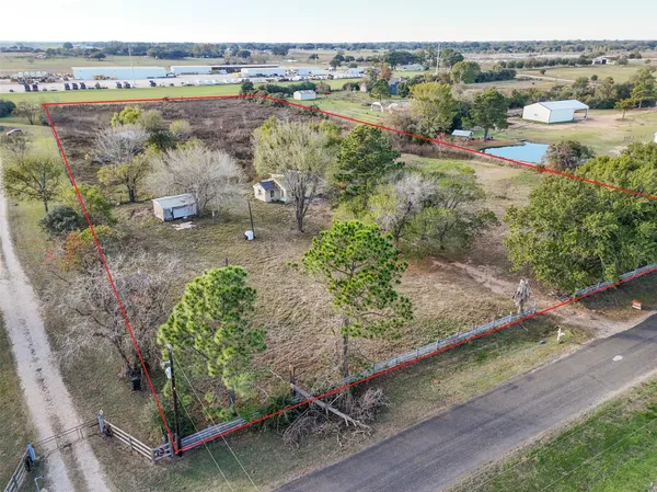 an aerial view of lake with residential house and outdoor space