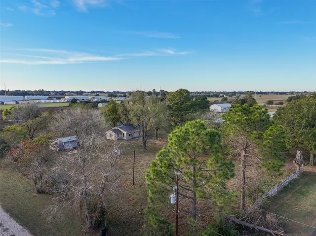 an aerial view of residential houses with outdoor space and river