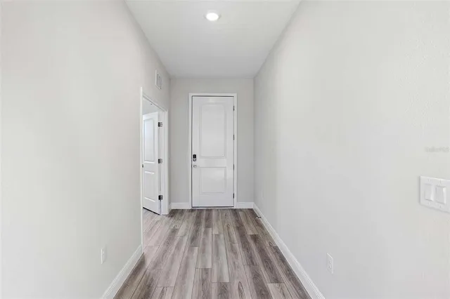 a view of a room with wooden floor