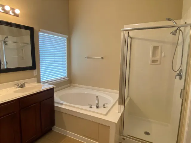 a bathroom with a bathtub and a sink