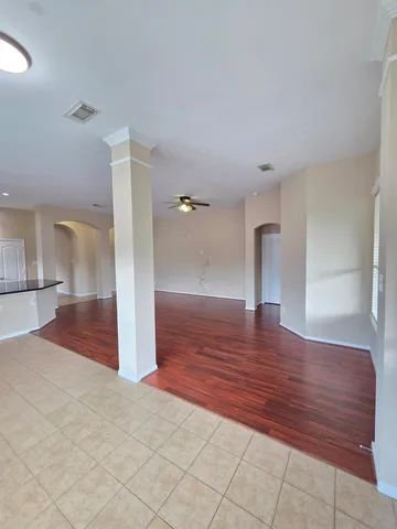 a view of empty room with wooden floor