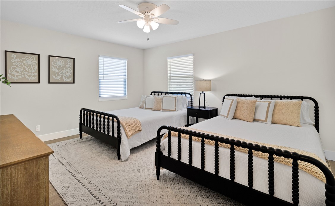 7989 143rd Street Sebastian, FL 32958 - Photo 16 of 30 a bedroom with two beds and a night stand