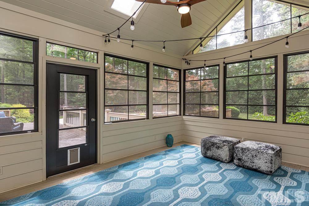 313 Jellison Court Raleigh, NC 27615 - Photo 11 of 30 Screened Porch with EZ Breeze windows, skylights, and ceiling fan.