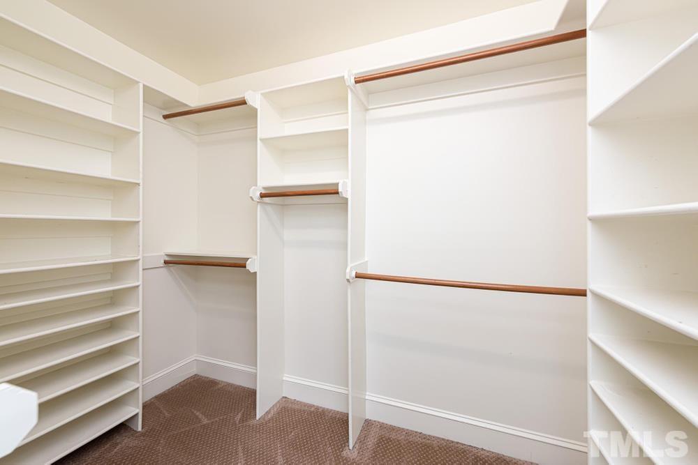 313 Jellison Court Raleigh, NC 27615 - Photo 21 of 30 Primary Bedroom large WIC with built ins and shelving.