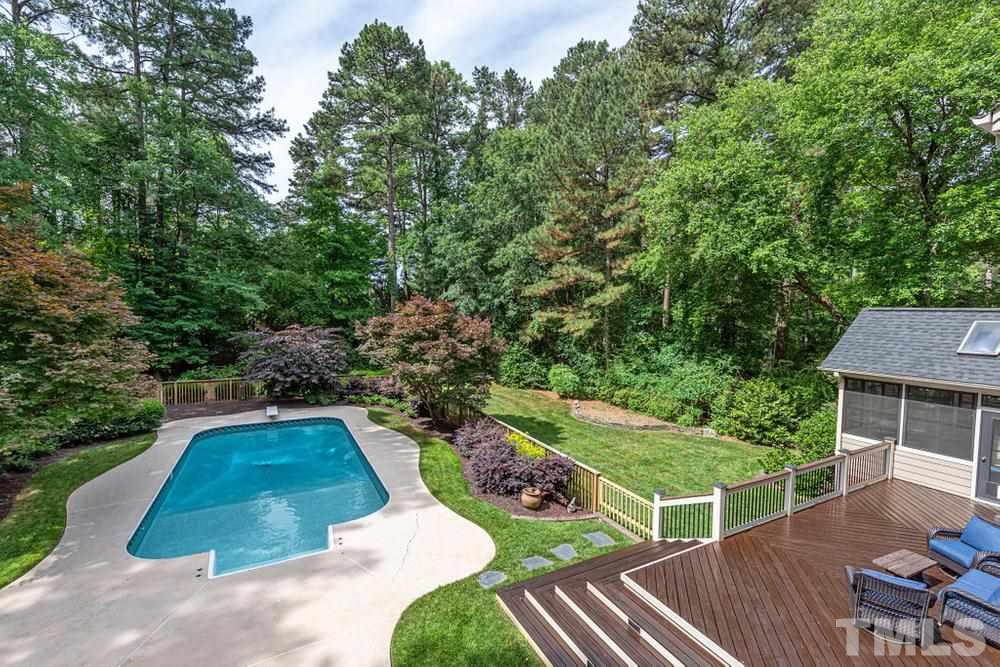 313 Jellison Court Raleigh, NC 27615 - Photo 27 of 30 Aerial view of backyard looking at deck, swimming pool, and flat backyard.