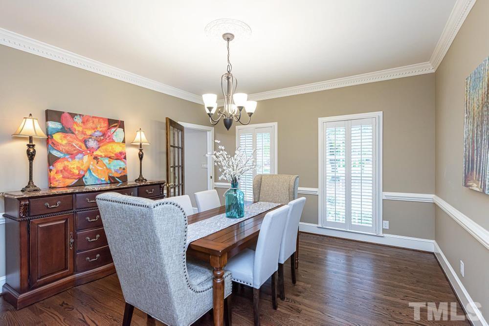 313 Jellison Court Raleigh, NC 27615 - Photo 4 of 30 Separate Dining Room with plantation shutters, crown molding, and chair railing.