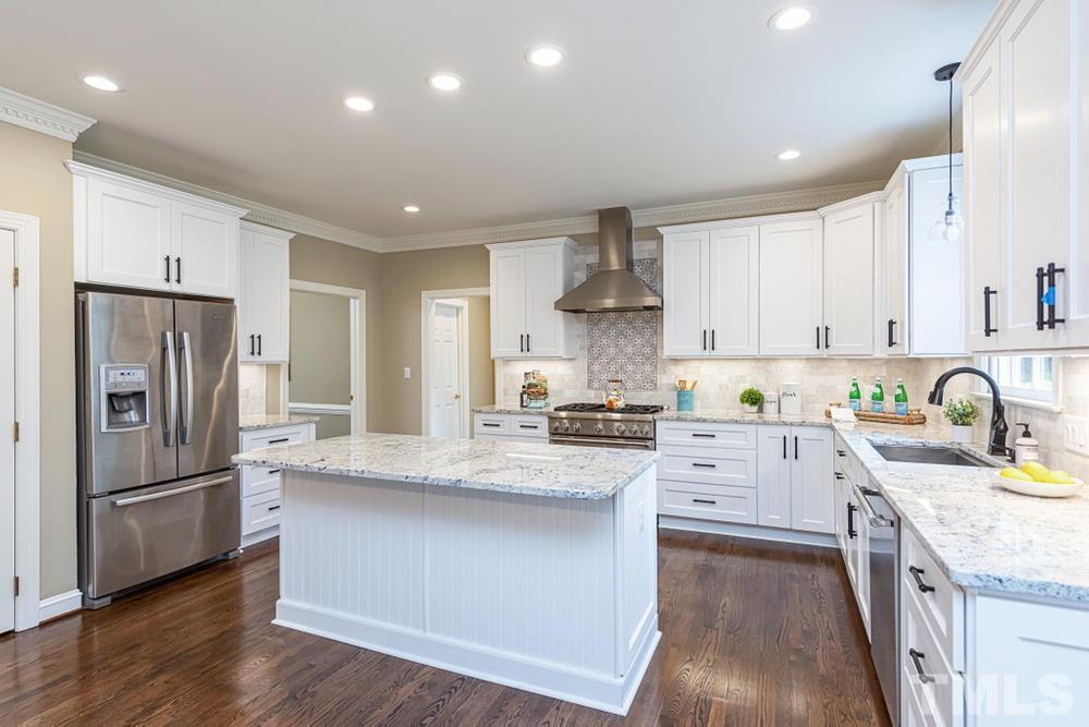 313 Jellison Court Raleigh, NC 27615 - Photo 5 of 30 Gourmet Kitchen featuring granite counters, island w/overhand, and lots of cabinet space.