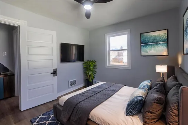 a bedroom with a bed and a flat screen tv