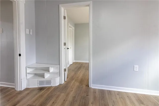 a view of walk in closet with wooden floor
