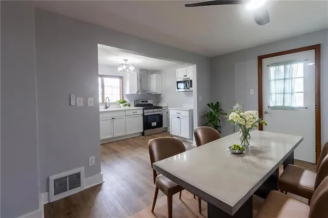 a kitchen with a table and chairs in it