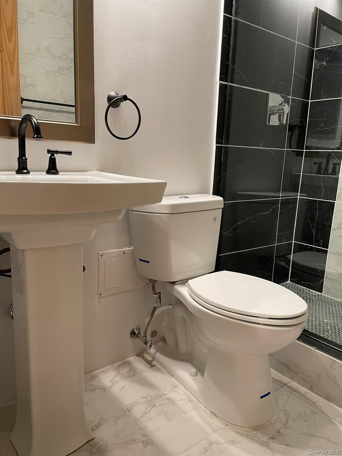 301 West 110th Street, Unit 14F Manhattan, NY 10026 - Photo 13 of 18 Bathroom with toilet, tiled shower, and marble finish floor
