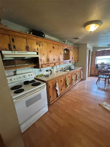 a kitchen with stainless steel appliances granite countertop a stove and a sink